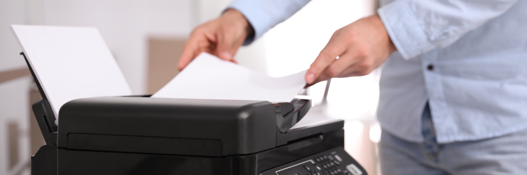 Employee using modern printer in office, closeup