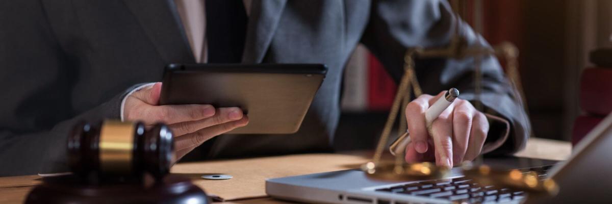 lawyer working on tablet and laptop