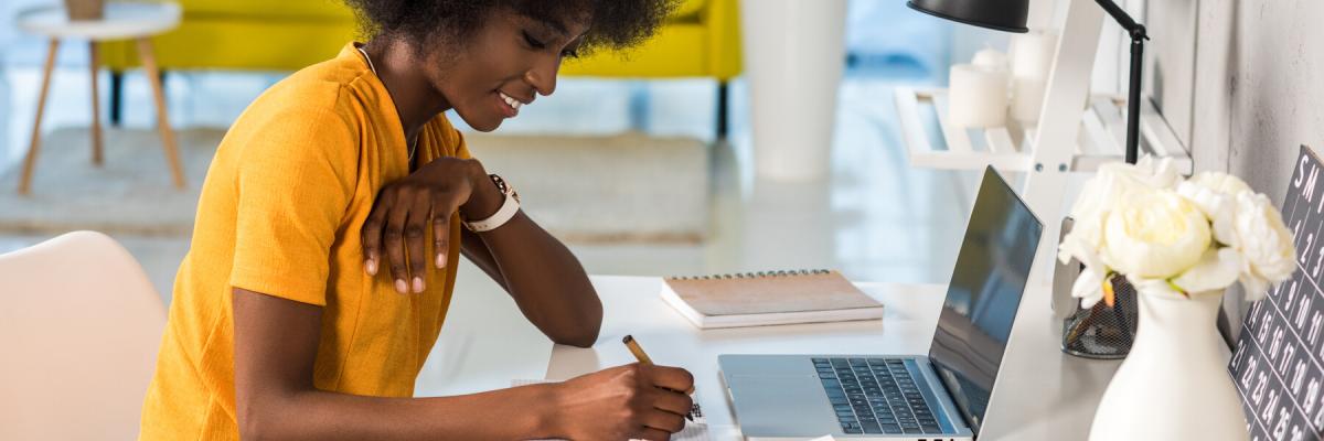 side view of smiling remote worker working on documents